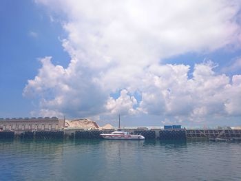 Built structures in water against cloudy sky