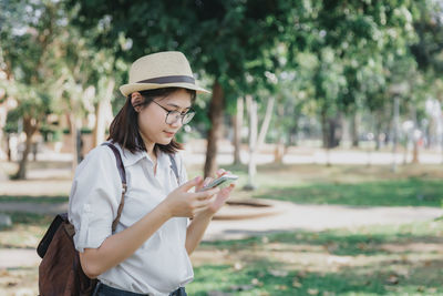 Young woman using smart phone outdoors