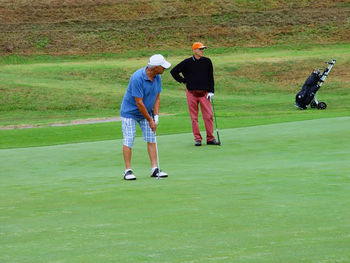 Full length of friends on golf course