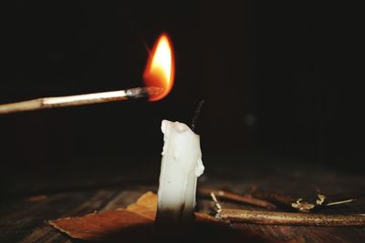 Close-up of illuminated candles on table