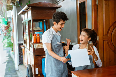 Side view of woman using digital tablet