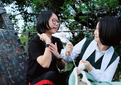 Teenage friends talking at park