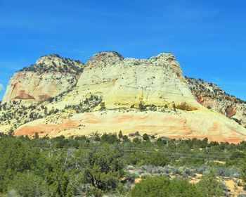 Low angle view of mountain against blue sky