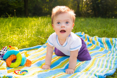 Close-up baby boy on picnic blanket at park