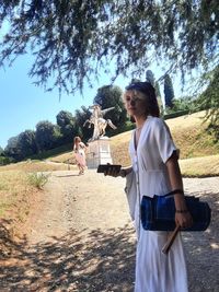 Young woman walking in giardini boboli during a hot summer day 