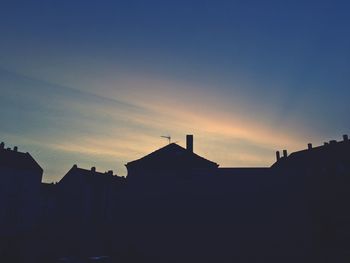 Silhouette buildings against sky during sunset