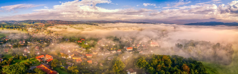 High angle view of townscape against sky with fog in the foreground. panorama 