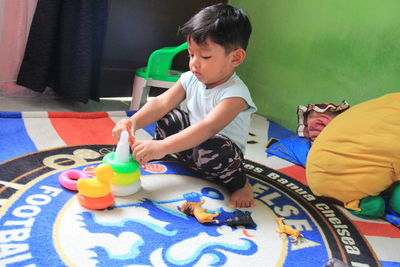 Cute boy playing with toy toys