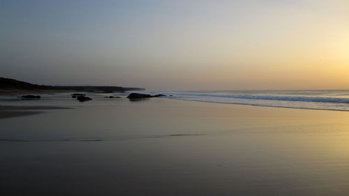 Scenic view of sea against clear sky during sunset