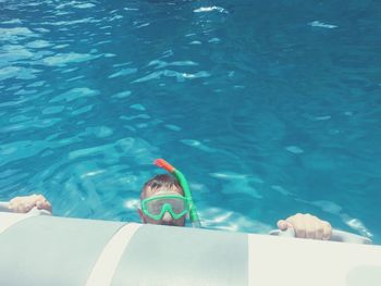 High angle portrait of man wearing scuba mask while swimming in sea