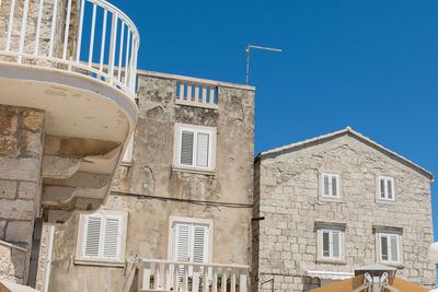 Low angle view of building against clear blue sky