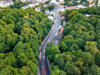 Aerial view of road amidst trees in city