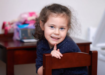 Pretty girl posing for a portrait during a video chat with grandma