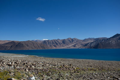 Scenic view of land and mountains against sky