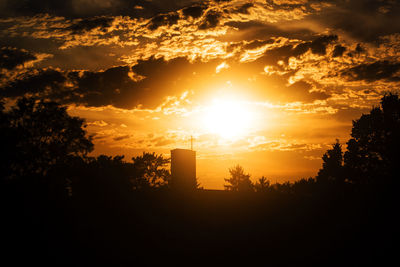 Silhouette trees against sky during sunset