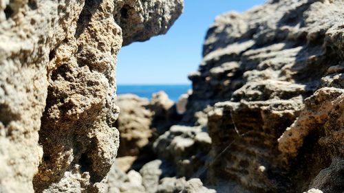 Close-up of rock formation against sea