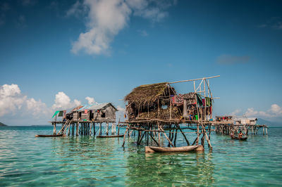 Ship moored in sea against sky