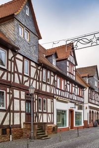 Street with historical half-timbered house in budingen, hesse, germany