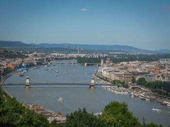 High angle view of river amidst buildings in city against sky