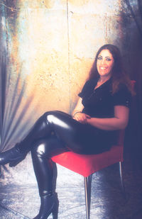 Portrait of young woman sitting outdoors