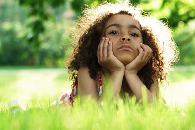 Portrait of young woman sitting on grass