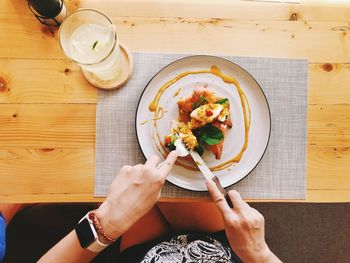 High angle view of hand holding food on table