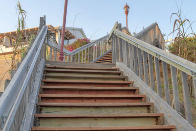 Low angle view of staircase by building against sky