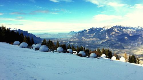 Scenic view of snow covered mountains against sky