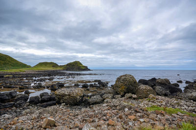 Rocks on beach against sky