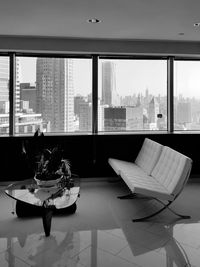 Chairs and table by window in city