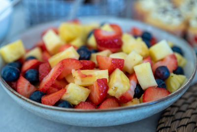 Close-up of chopped fruits in bowl on table