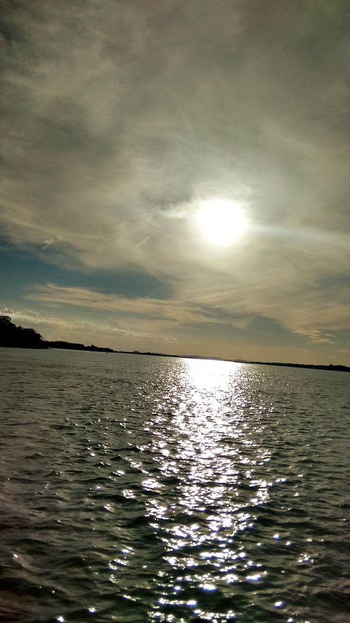 water, sky, tranquil scene, scenics, tranquility, waterfront, beauty in nature, sea, cloud - sky, reflection, sun, nature, rippled, cloudy, idyllic, sunset, cloud, sunlight, horizon over water, outdoors