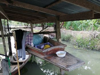 Abandoned boat in lake against buildings