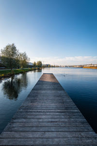 View of wooden pier in phoenixsee lake against sky