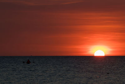 Scenic view of sea against orange sky