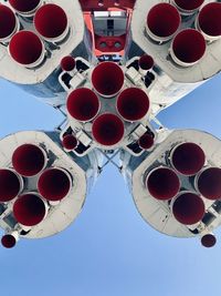 Low angle view of red lights against clear blue sky