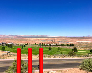 Scenic view of field against clear blue sky