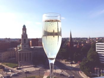 Close-up of drink against cityscape