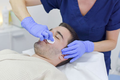 Midsection of man lying on bed