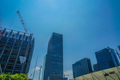 Low angle view of modern buildings against clear blue sky