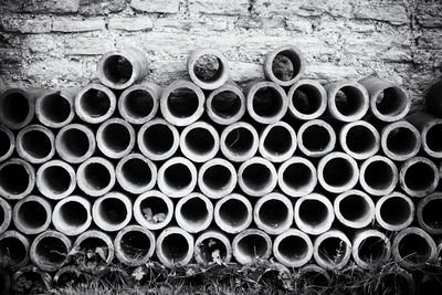 Pile of terracotta tubes arranged against wall