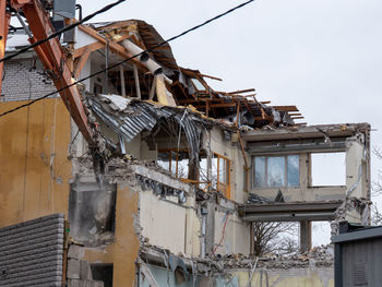 Low angle view of abandoned building against sky