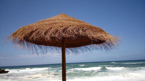 Parasol at beach against sky