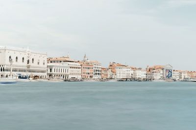 Buildings by grand canal against sky in city