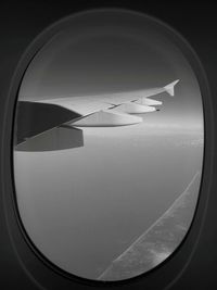 Cropped image of airplane flying above sky