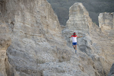 One man trail running on a sandy terrain made of old mining waste