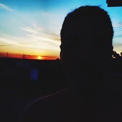 Close-up portrait of silhouette man against sky during sunset