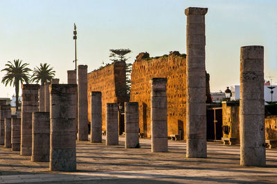 Hassan ii tower columns minaret and a brick wall at sunset, rabat, morocco