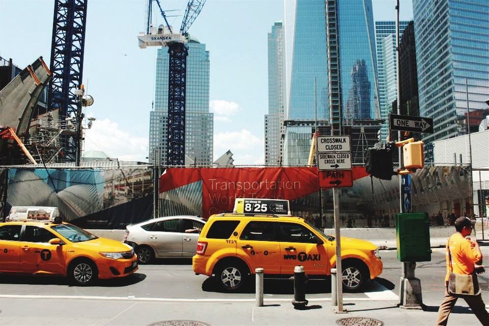 CARS MOVING ON ROAD IN CITY