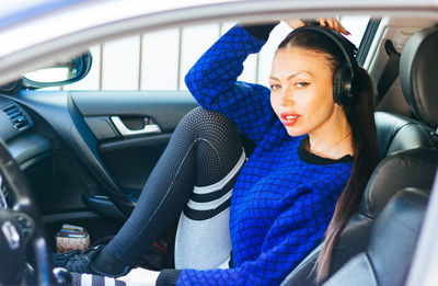 Portrait of woman sitting in car